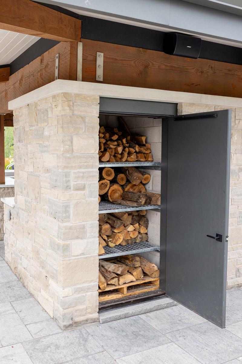 custom metal door and shelving for outdoor firewood