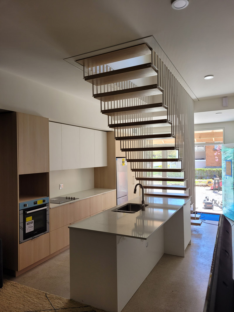 Beautiful custom floating stairs with metal railings holding it up