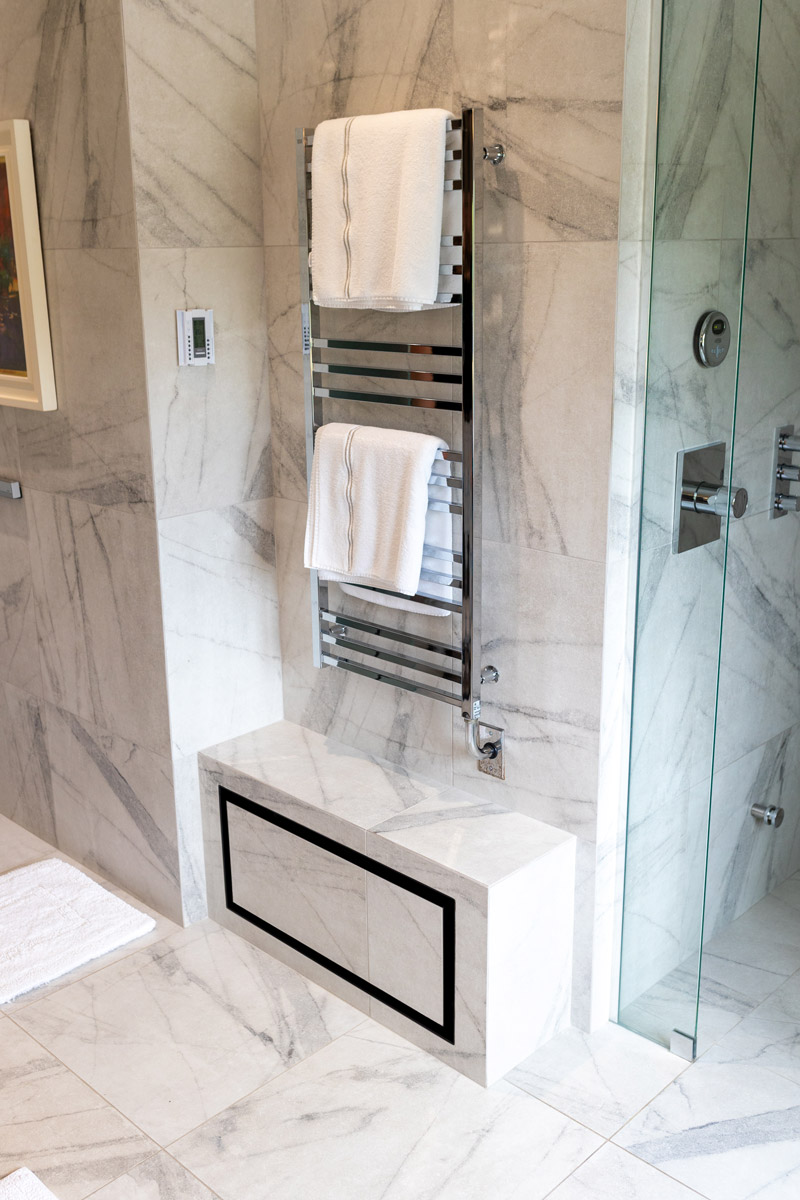 A metal towel rack on a wall in a bathroom